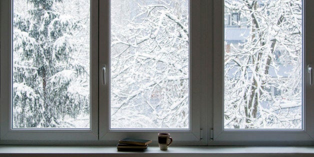 Books on the window in winter, snow in the background