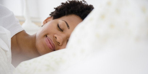 Serene Black woman laying in bed