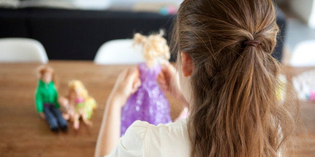 girl of 8 years old playing with dolls