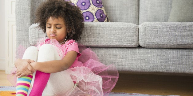 African American girl frowning in living room