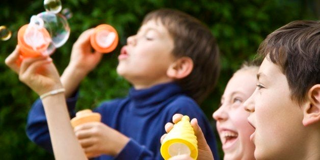 Children blowing bubbles