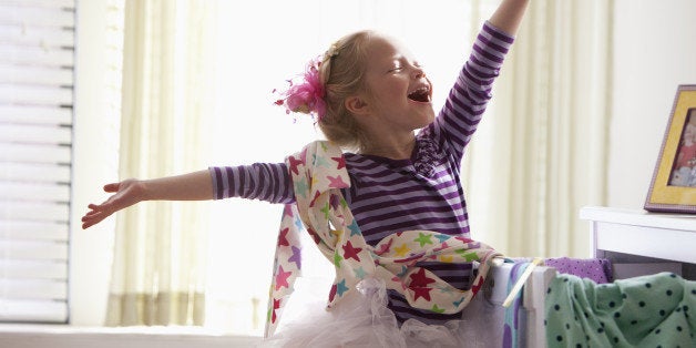 Caucasian girl singing with arms outstretched