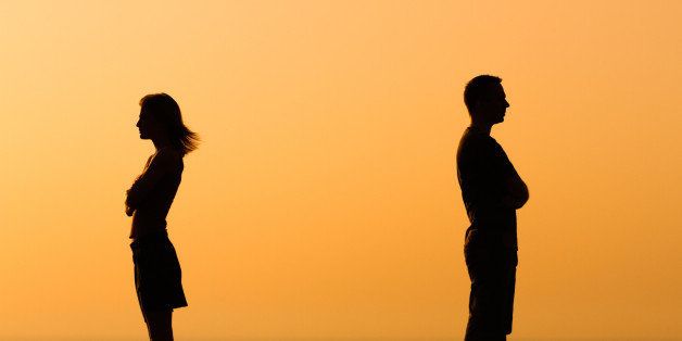 Silhouette of a angry woman and man on each other.