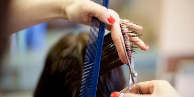 Woman 40s getting hair cut at hairdresser