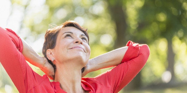 USA, New York State, New York City, Happy mature woman raising hands in park