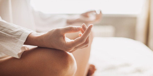 Hands of young beautiful woman practicing yoga indoors