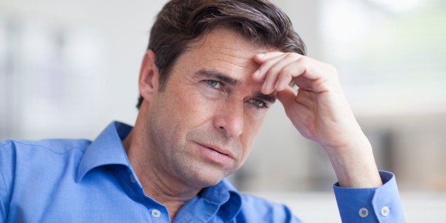 Mature man looking anxious, close up