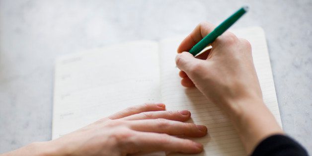 Woman writing on diary