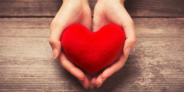 female hands giving red heart