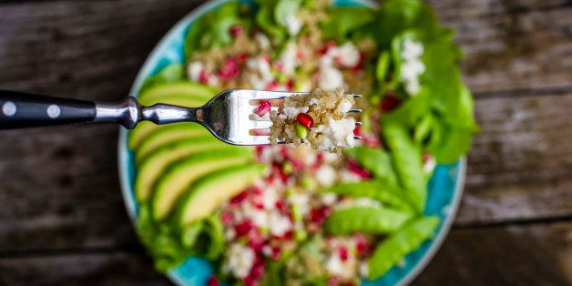 Quinoa salad with feta, pomegranate, avocado and snow peas on plate