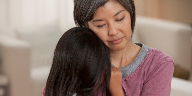 Asian mother hugging daughter