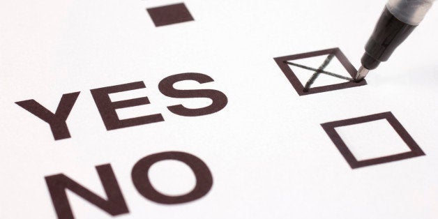 Putting a cross in a box. Voting, making a positive choice yes to a question. Selective focus with limited depth of field.