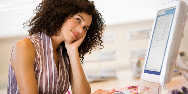 Businesswoman daydreaming at desk