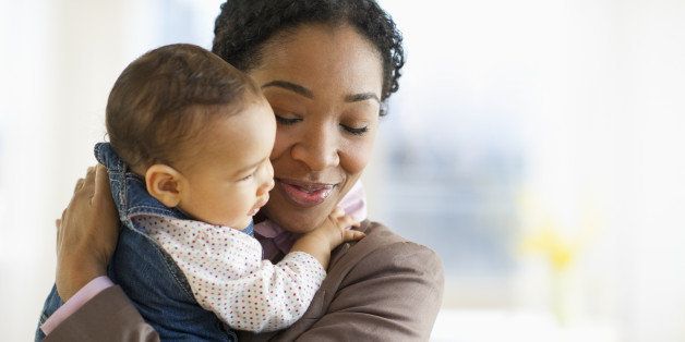 Mixed race woman hugging baby