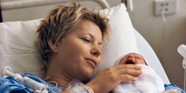 Mother holding newborn baby in hospital