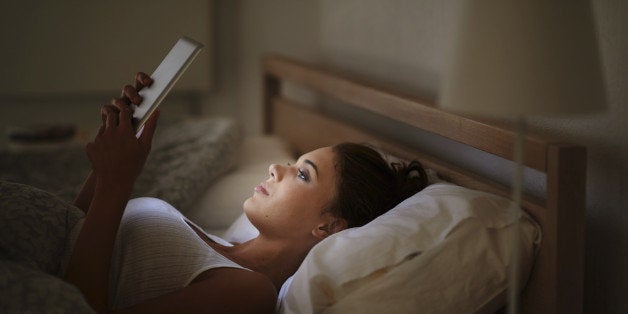 Cropped shot of an attractive young woman using her tablet in bed