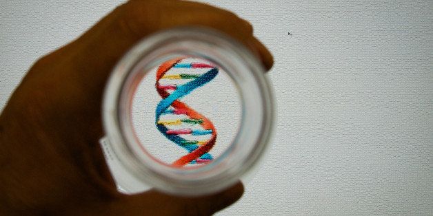 Looking down at an image of a double stranded DNA helix in a test-tube held in the hand of a scientist.