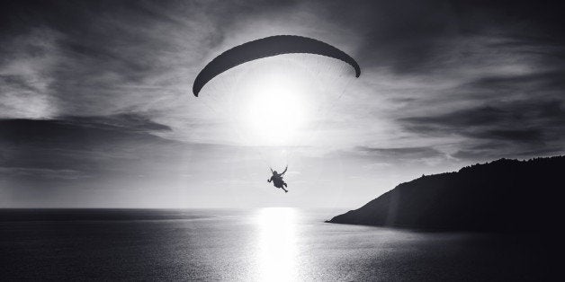 parachutist flying at sunset...