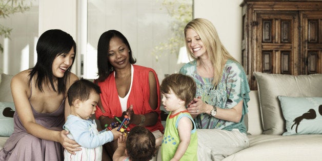 Three mothers and their children playing together