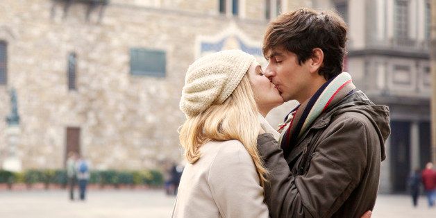 city break, outdoors, tourism, young couple, people, heterosexual couple, day, casual, winter, travel destination, vacations, kissing, standing, blonde, long hair, hat, embracing, touching, hug, jacket