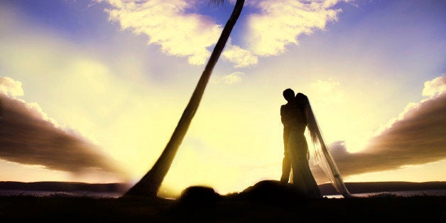 This wedding photo is taken at Maui Hawaii during the sunset, featuring a romantic tone