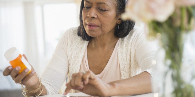 Mixed race woman researching medication on tablet computer