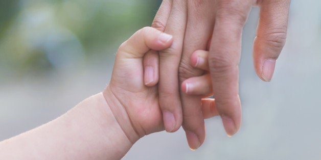 Mother and chilid holding hands, walk together.