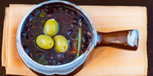 TORONTO, ONTARIO, CANADA - 2015/12/11: Cuban cuisine: black beans soup served in a clay pot and garnished with three green olives. (Photo by Roberto Machado Noa/LightRocket via Getty Images)