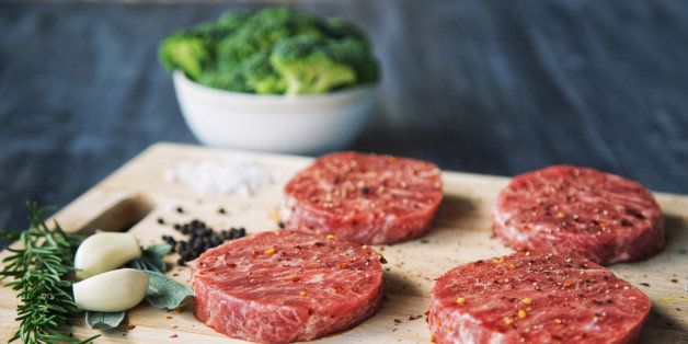 Premium raw Japanese beef steaks on cutting board with broccoli