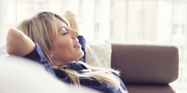 Relaxed young woman lying on couch.