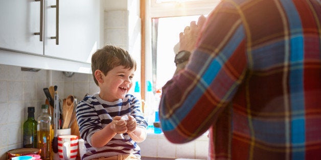 Father and son playing in the kitchen