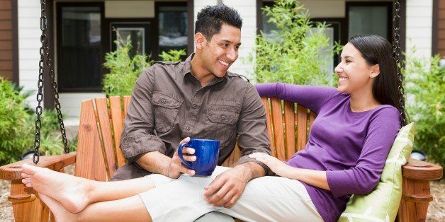 Young couple sitting on porch swing