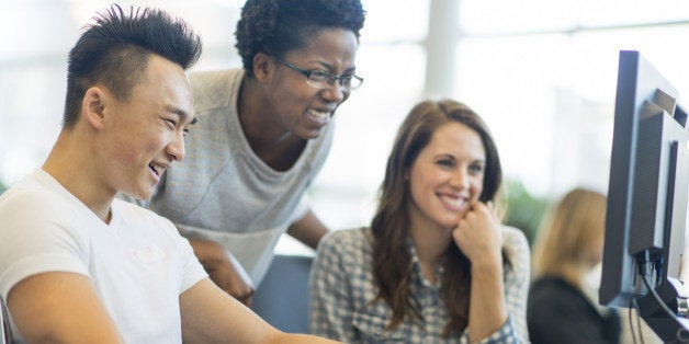 Diverse college students working on computers.