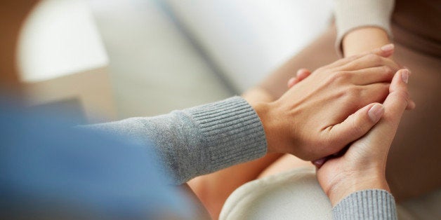 Close-up of psychiatrist hands together holding palm of her patient