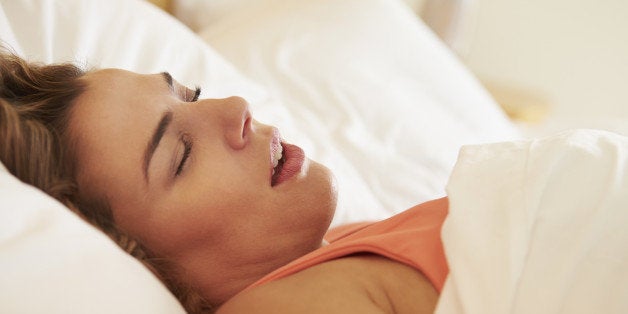 Close Up Of Overweight Woman Asleep In Bed Snoring On Her Own