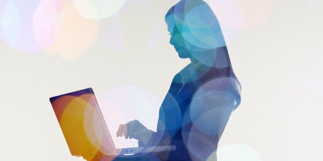 Businesswoman using laptop computer.Abstract colour effect.