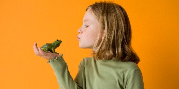 little girl about to kiss a frog