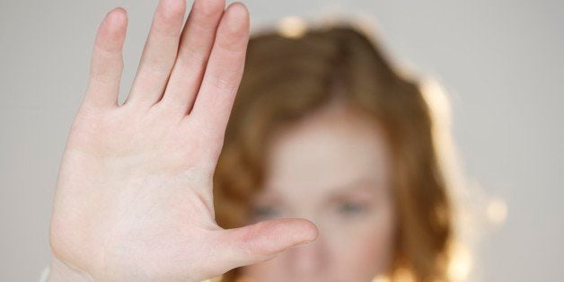 Redhead with flat palm raised