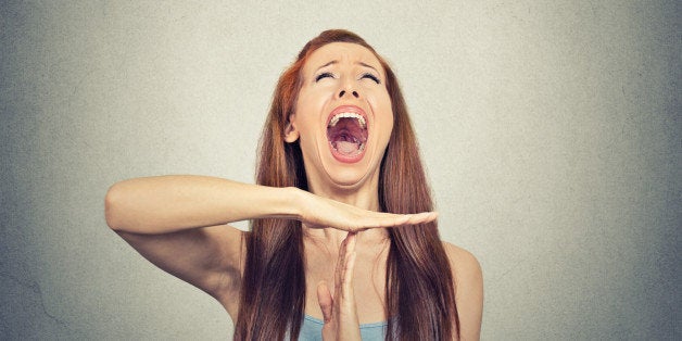 Young woman showing time out hand gesture, frustrated screaming to stop isolated on grey wall background. Too many things to do. Human emotions face expression reaction