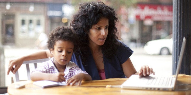 Mother and son working at cafe.