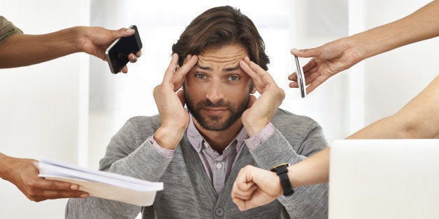 A cropped shot of a handsome businessman under strain as colleagues request various things from him