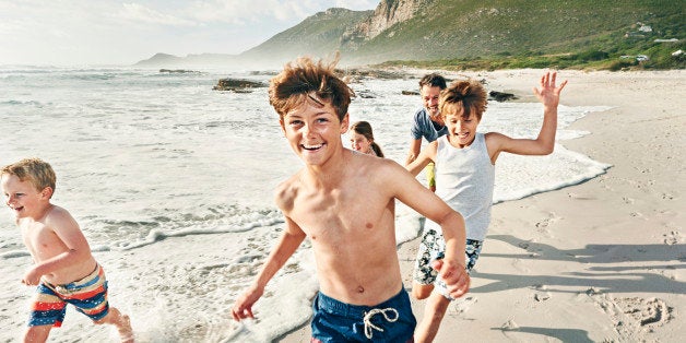 Father and kids playing on beach