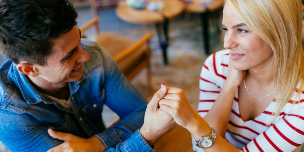 Beautiful couple in love flirting in restaurant and bonding