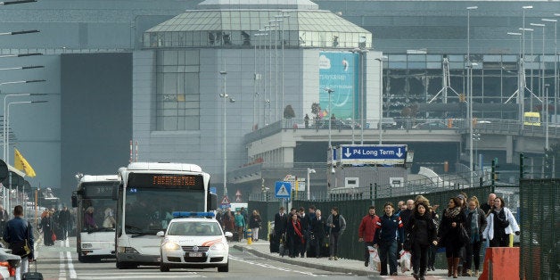 people are evacuated from Zaventem Airport in Brussels by bus after an explosion on Tuesday, March 22, 2016. Explosions, at least one likely caused by a suicide bomber, rocked the Brussels airport and subway system Tuesday, prompting a lockdown of the Belgian capital and heightened security across Europe. At least 26 people were reported dead. (AP Photo/Geert Vanden Wijngaert)