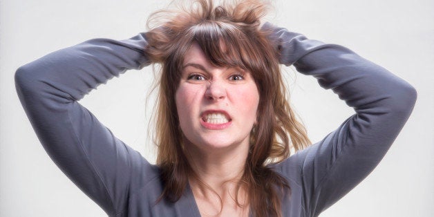 Young woman pulling her hair.