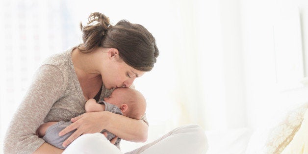 USA, New Jersey, Jersey City, Mother kissing baby boy (2-5 months ) in bed