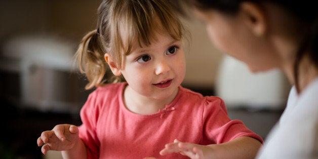 Child gifted mother with self-made dough heart - indoors at kitchen