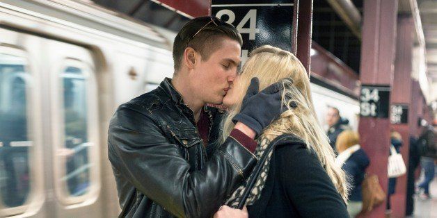 Romantic young couple kissing on New York City subway platform, New York, USA