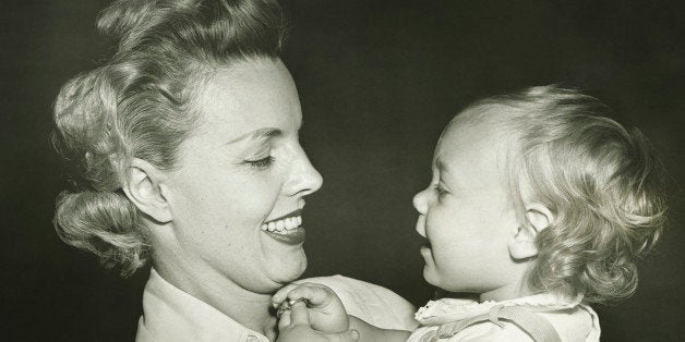 Woman holding daughter (12-18 months), (B&W), close-up
