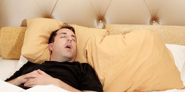 Man sleeping alone in bed